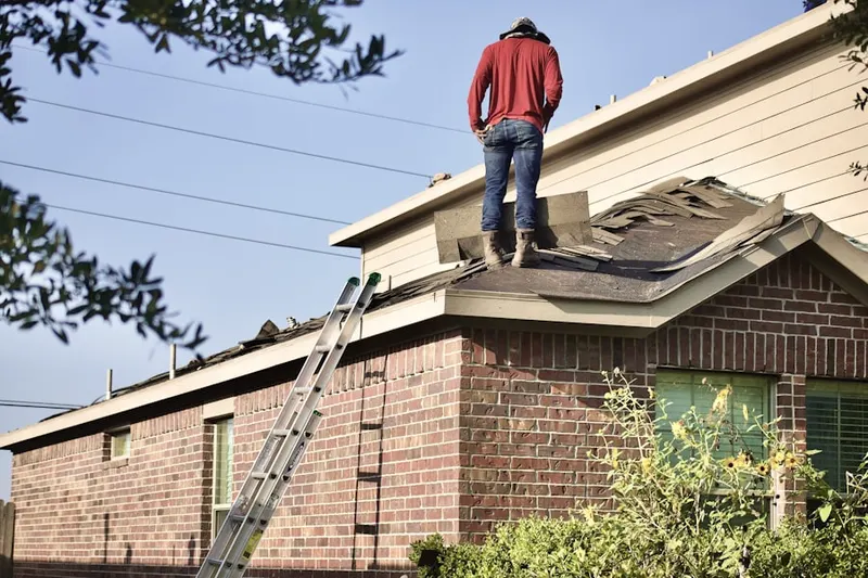 Professional roofer working on a residential roof in Olympic Valley